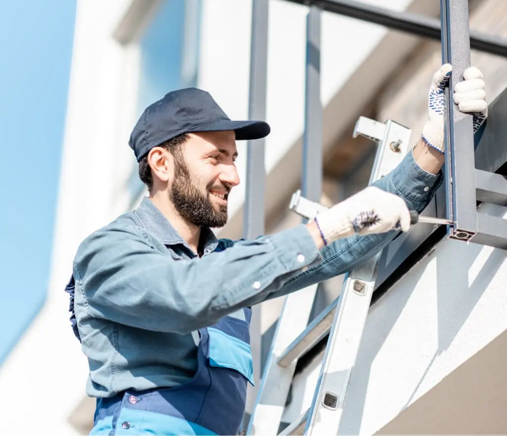 Builder mounting a balcony fence